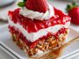 Layered strawberry pretzel salad with a crunchy pretzel crust, creamy cheesecake filling, and fresh strawberry gelatin topping.