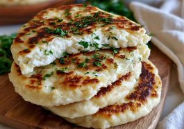Golden cottage cheese flagels sliced and served with cream cheese, showing a soft high-protein texture inside.