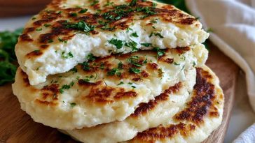 Golden cottage cheese flagels sliced and served with cream cheese, showing a soft high-protein texture inside.