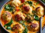 Coconut curry soup with dumplings, creamy broth, and aromatic herbs.