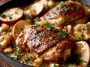 Tender chicken cooked in creamy apple cider sauce with herbs and apples.