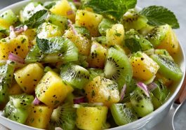 Fresh pineapple kiwi salad with juicy pineapple chunks, sliced kiwi, mint leaves, and a light citrus dressing.