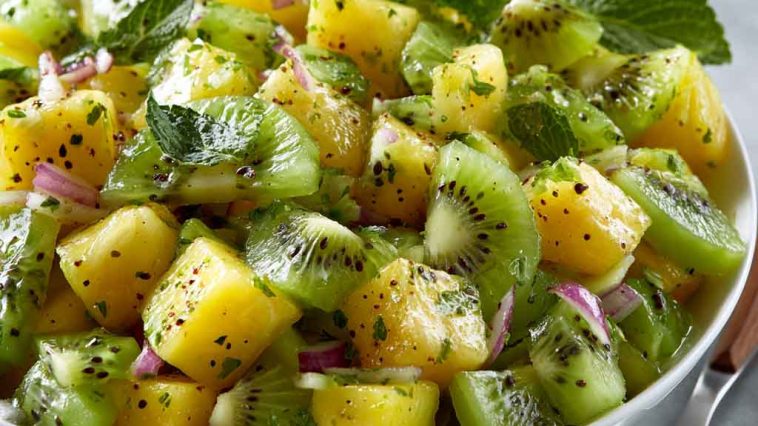 Fresh pineapple kiwi salad with juicy pineapple chunks, sliced kiwi, mint leaves, and a light citrus dressing.