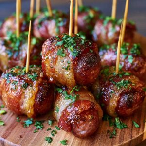 Crispy bacon wrapped kielbasa bites cooked until golden and served warm.
