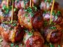 Crispy bacon wrapped kielbasa bites cooked until golden and served warm.