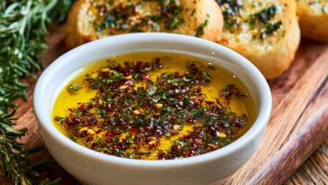 Bread dipping oil with herbs, garlic, and olive oil served with crusty bread.