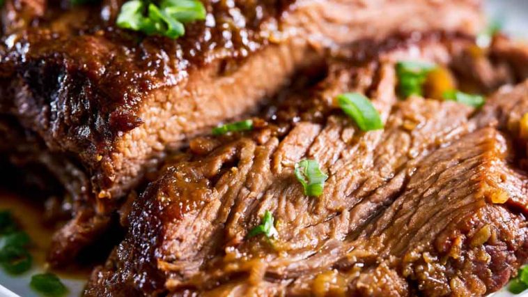 Tender slow cooker beef brisket with rich sauce, made with simple ingredients.