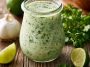 Creamy garlic lime cilantro sauce in a bowl with fresh herbs.