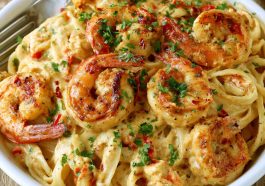 Creamy Cajun shrimp and crab pasta with tender seafood, rich sauce, and perfectly cooked pasta, garnished with parsley.