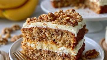 Moist banana cake with walnuts and creamy frosting, rich and fluffy.