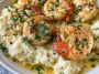 Creamy garlic butter shrimp served over fluffy mashed potatoes, garnished with fresh parsley and coated in a rich buttery sauce.