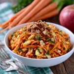 Fresh carrot apple salad made with shredded carrots, crisp apples, raisins, and a light creamy dressing.