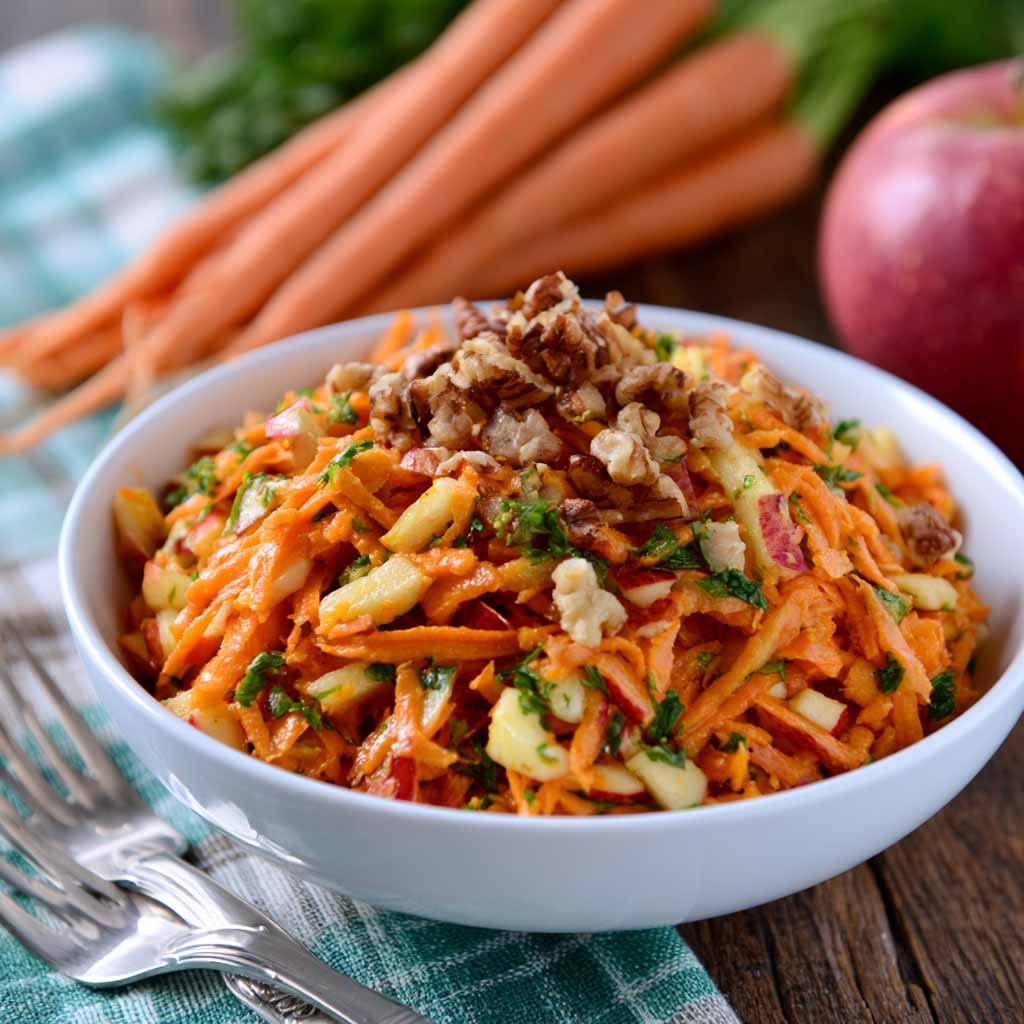 Fresh carrot apple salad made with shredded carrots, crisp apples, raisins, and a light creamy dressing.