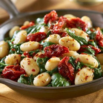 Tuscan butter beans with spinach and sun-dried tomatoes in a creamy sauce.
