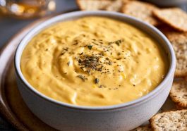 Warm creamy beer cheese dip served with pretzels for dipping.