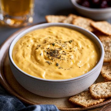 Warm creamy beer cheese dip served with pretzels for dipping.