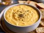 Warm creamy beer cheese dip served with pretzels for dipping.