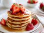 Pancake recipes – Stack of golden pancakes topped with syrup and butter.