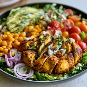 High protein chicken salad with Greek yogurt dressing – A bowl of shredded chicken, crisp vegetables, and creamy Greek yogurt dressing.