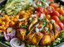 High protein chicken salad with Greek yogurt dressing – A bowl of shredded chicken, crisp vegetables, and creamy Greek yogurt dressing.