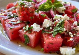 “Bowl of watermelon feta salad with fresh mint and lime dressing, served as a colorful summer side dish.”