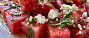 “Bowl of watermelon feta salad with fresh mint and lime dressing, served as a colorful summer side dish.”