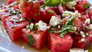“Bowl of watermelon feta salad with fresh mint and lime dressing, served as a colorful summer side dish.”
