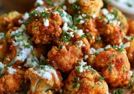 Crispy buffalo cauliflower bites coated in spicy buffalo sauce and served with ranch dressing and celery sticks.