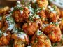 Crispy buffalo cauliflower bites coated in spicy buffalo sauce and served with ranch dressing and celery sticks.