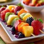 Fruit kabobs with strawberries, pineapple, and grapes – Colorful skewers of fresh fruit arranged on a platter.