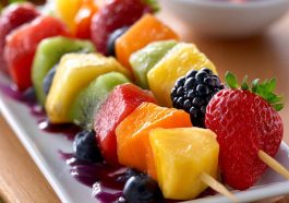 Fruit kabobs with strawberries, pineapple, and grapes – Colorful skewers of fresh fruit arranged on a platter.