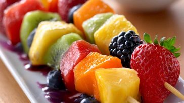 Fruit kabobs with strawberries, pineapple, and grapes – Colorful skewers of fresh fruit arranged on a platter.