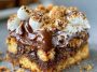 Gooey s'mores cookie bars layered with melted chocolate, toasted marshmallows, and a soft cookie base.