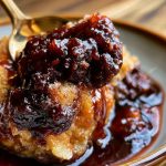 Warm Southern chocolate cobbler with a rich fudgy sauce beneath a soft chocolate cake topping, served with a scoop of vanilla ice cream.