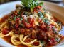 Crispy Chicken Romano topped with Romano cheese crust, served with a creamy pasta side and garnished with fresh parsley.