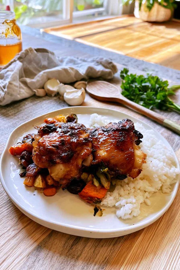 Juicy honey garlic chicken thighs coated in a sticky sweet garlic sauce and garnished with fresh parsley.