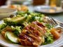 Fresh Chicken Avocado Salad with grilled chicken, sliced avocado, cherry tomatoes, cucumber, and mixed greens in a bowl.