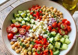 “Colorful chickpea salad with tomatoes, cucumbers, and parsley”