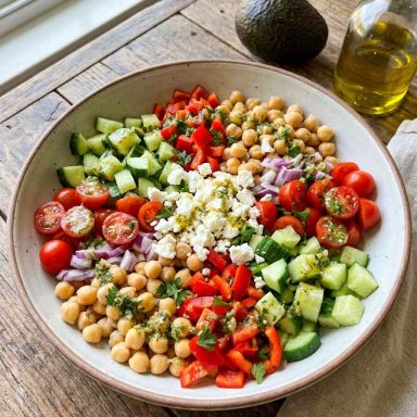 “Colorful chickpea salad with tomatoes, cucumbers, and parsley”