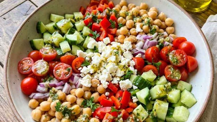 “Colorful chickpea salad with tomatoes, cucumbers, and parsley”