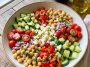 “Colorful chickpea salad with tomatoes, cucumbers, and parsley”