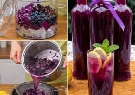 Glass of purple cabbage and blueberry detox drink garnished with fresh blueberries.